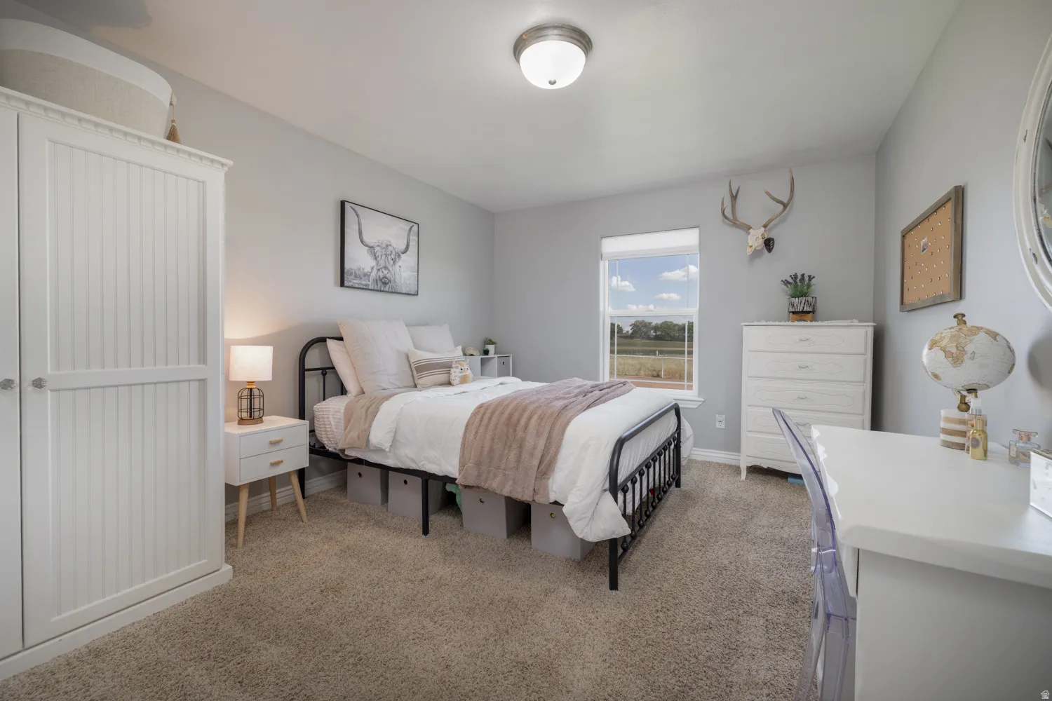 Bedroom with light colored carpet and baseboards