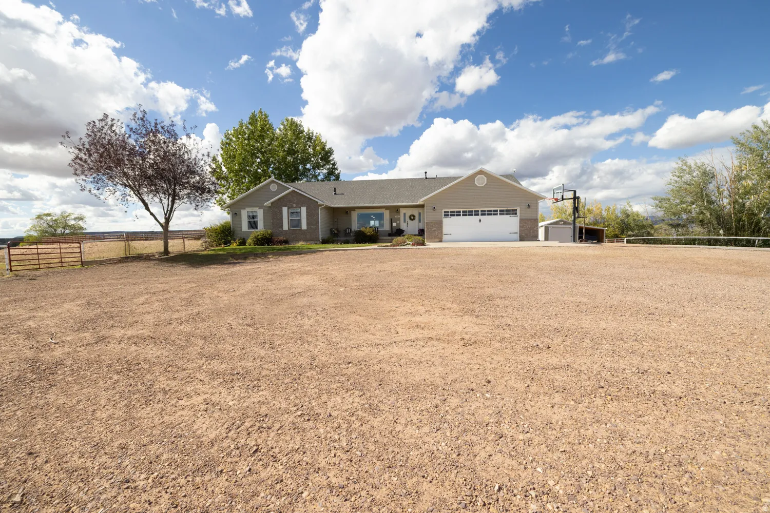 Single story home with a garage, driveway, and brick siding