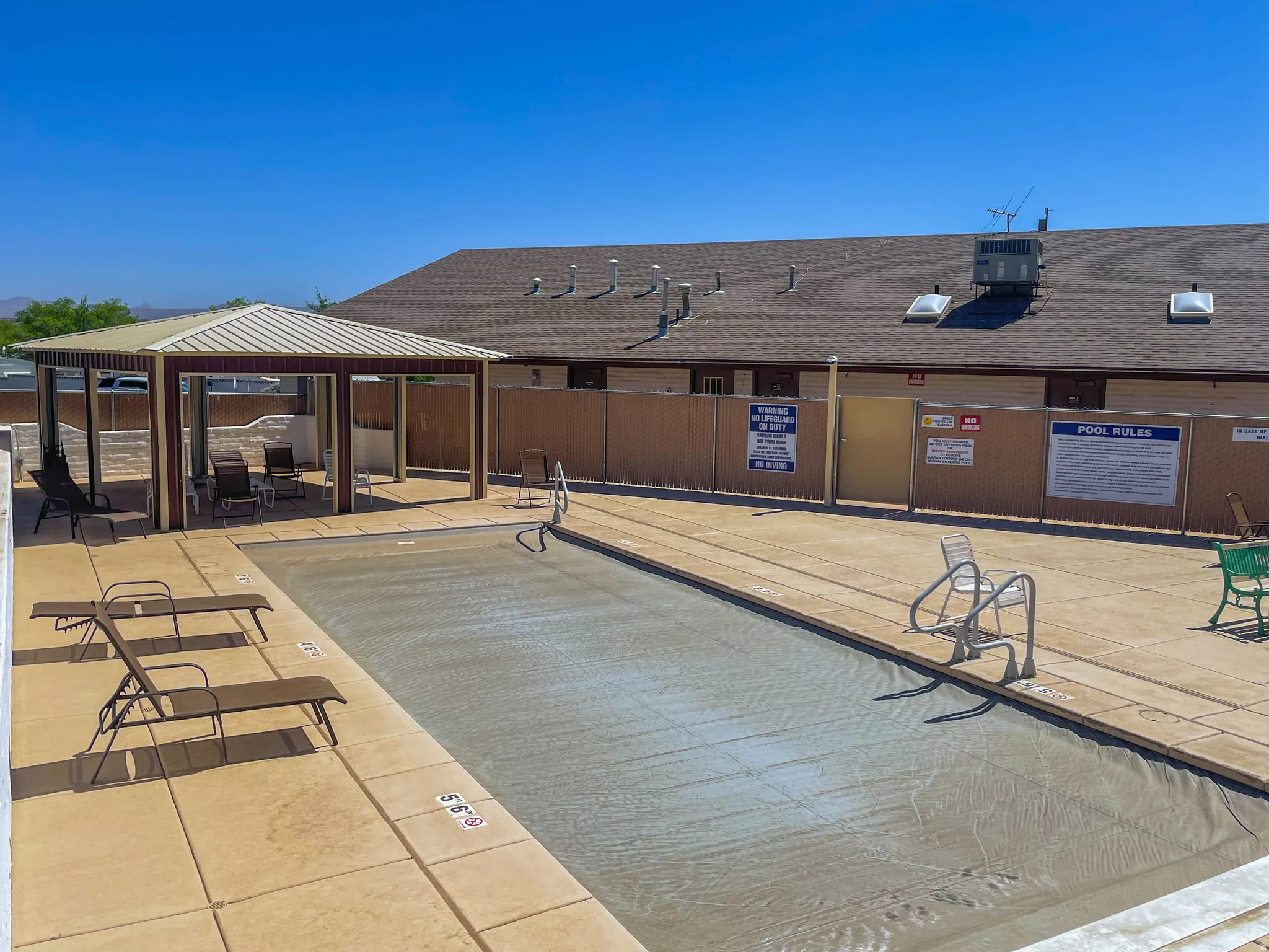 Community pool with a gazebo and a patio area