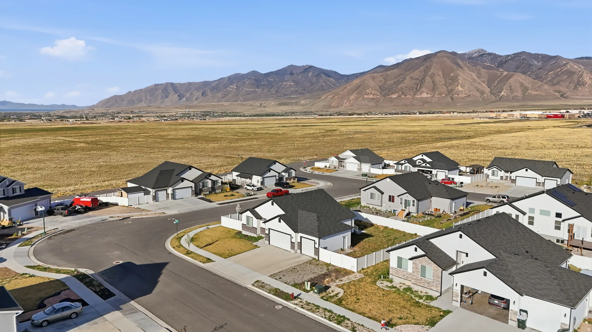 Aerial perspective of suburban area with a mountainous background