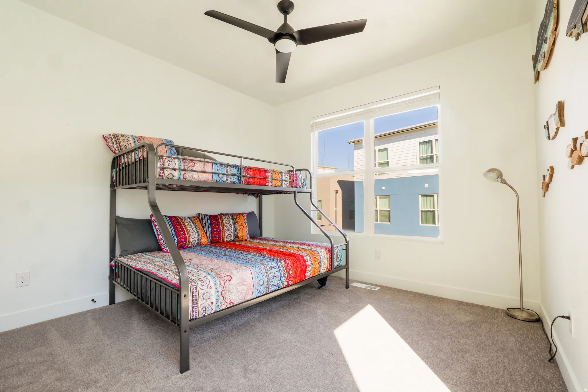 Bedroom featuring ceiling fan and light carpet