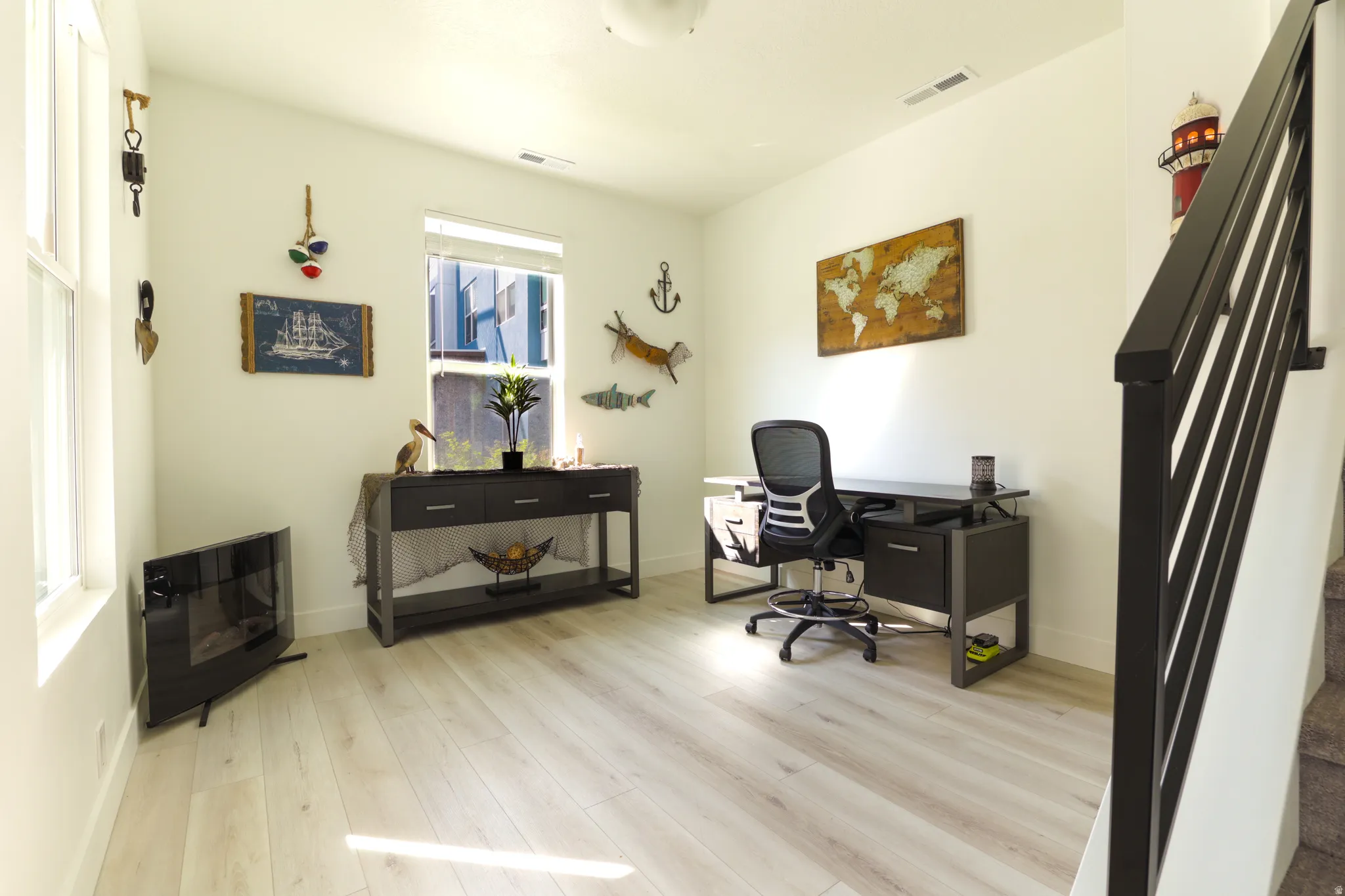 Office space with light wood-type flooring and baseboards