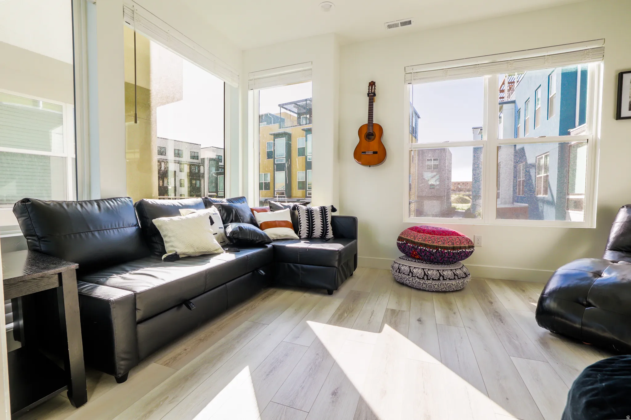 Living room featuring light wood finished floors and plenty of natural light