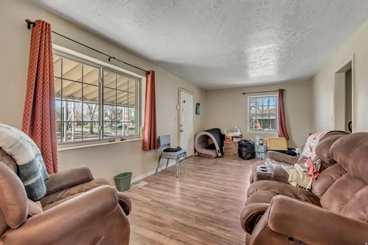 Living area featuring wood finished floors and a textured ceiling