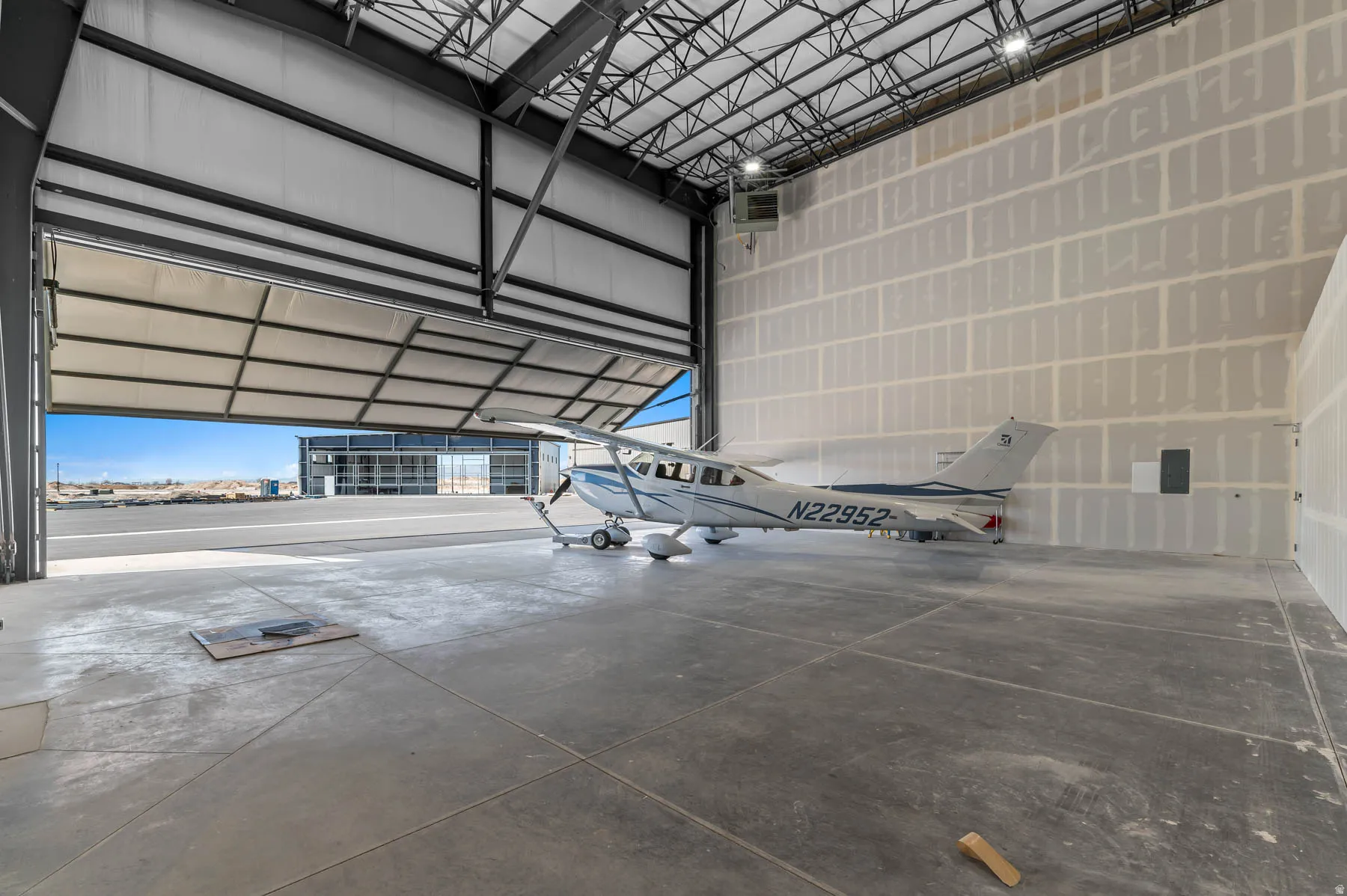 Garage featuring metal wall and a heating unit
