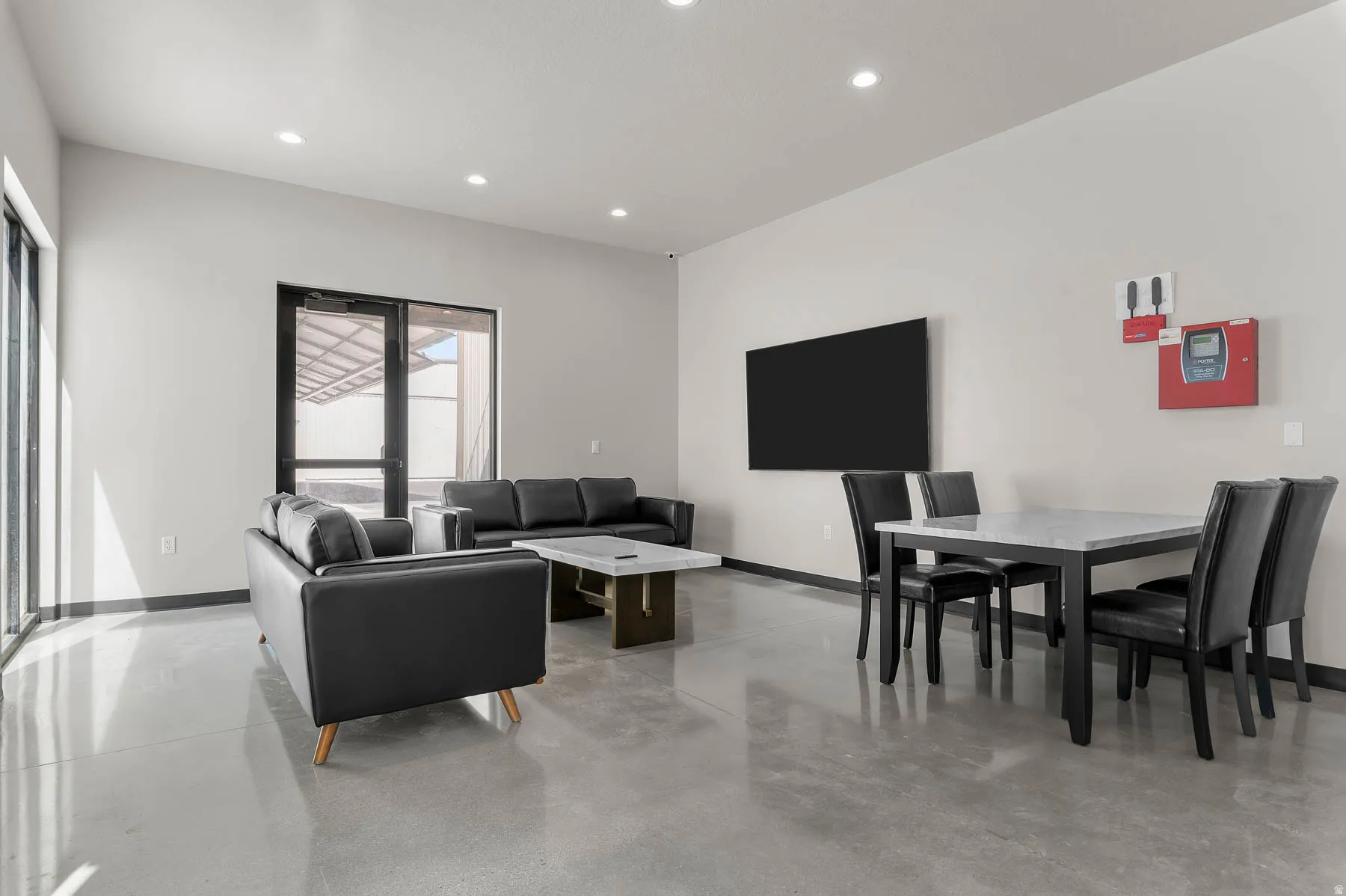 Living room with concrete flooring and recessed lighting