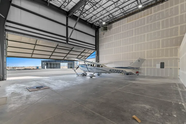 Garage featuring metal wall and a heating unit