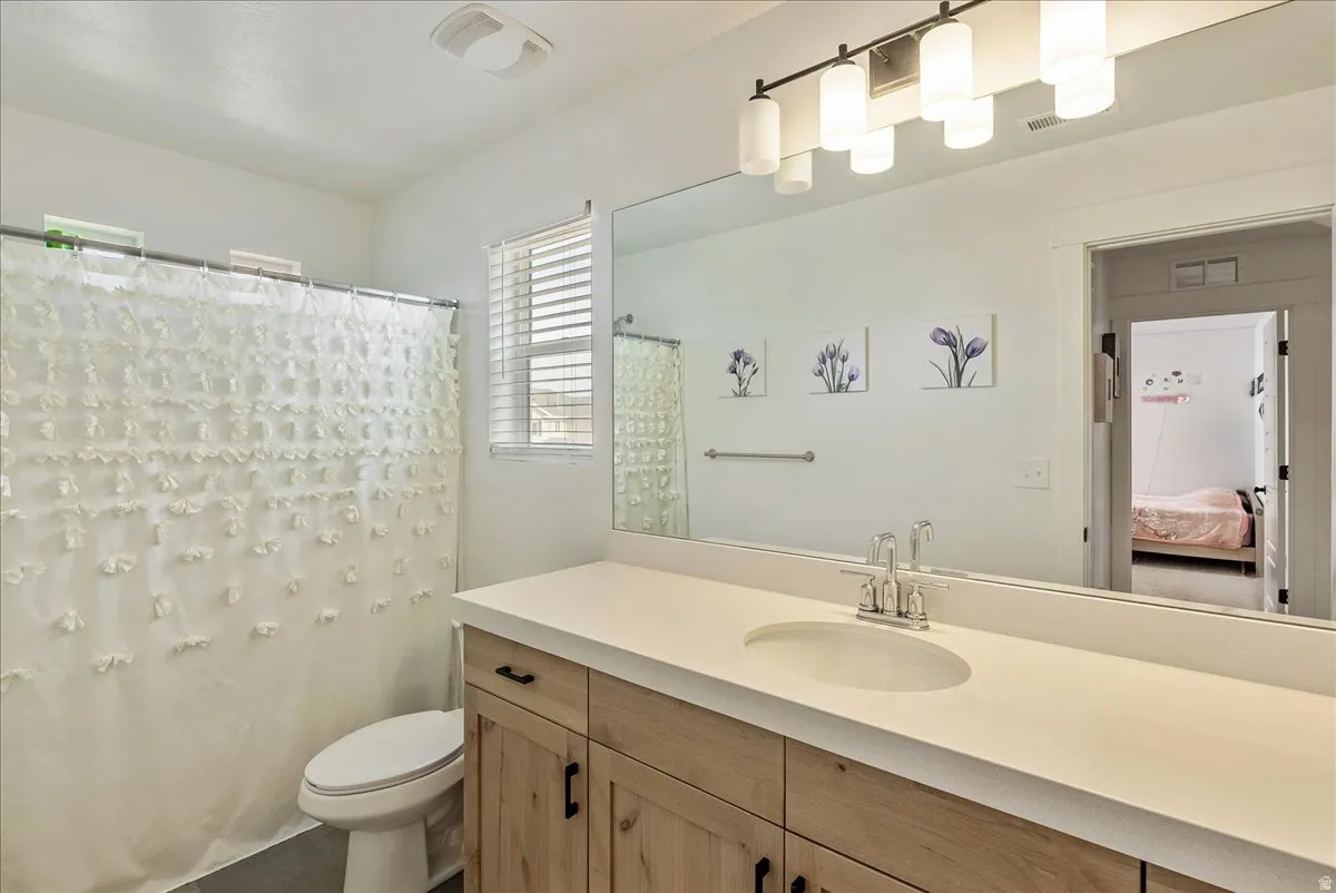 Bathroom featuring vanity, a shower with curtain, and ensuite bath