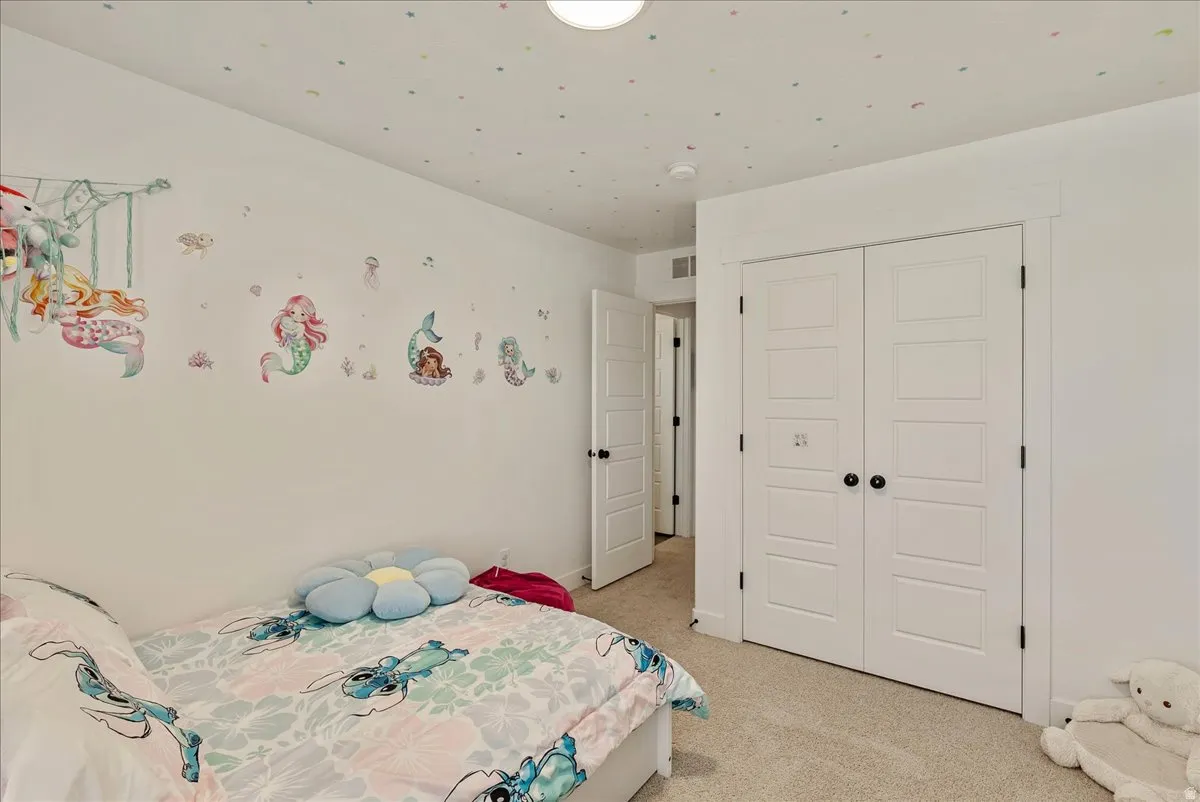 Bedroom featuring a closet and light colored carpet