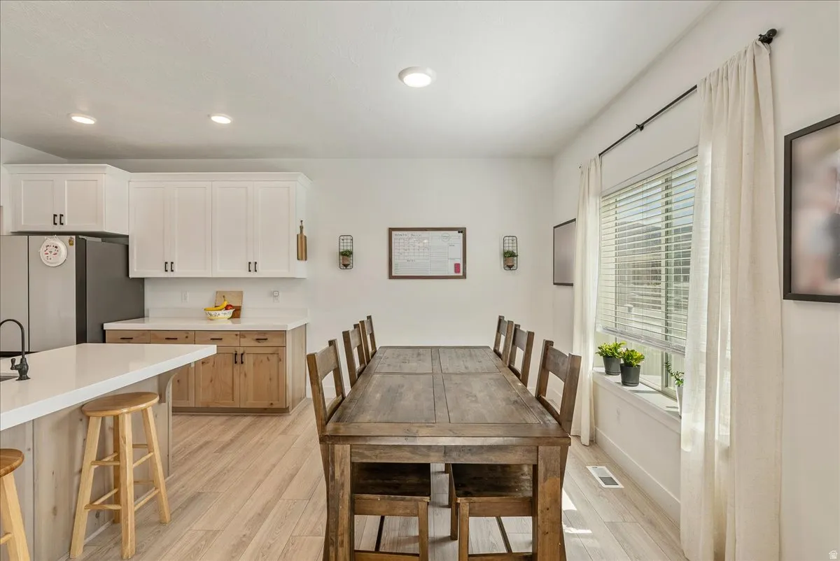 Dining area featuring light wood-style flooring and recessed lighting