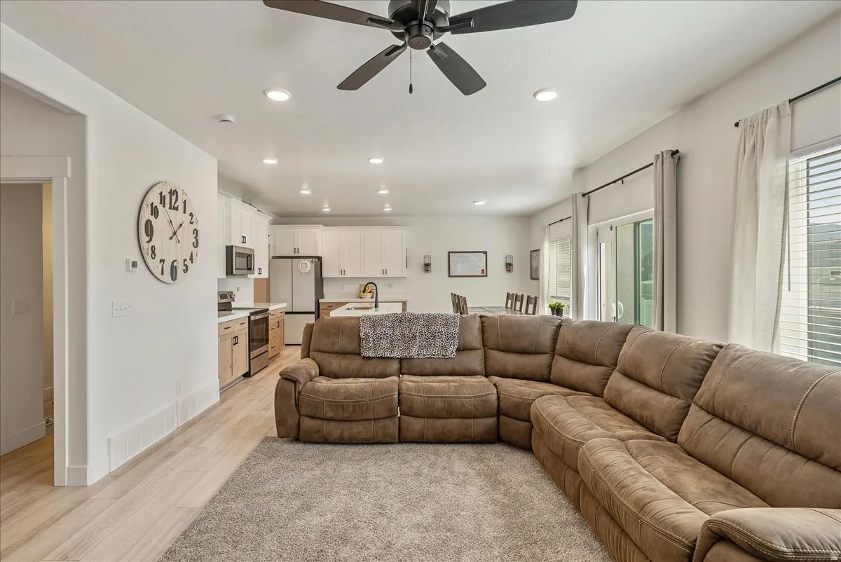 Living area featuring ceiling fan, recessed lighting, and light wood-style floors