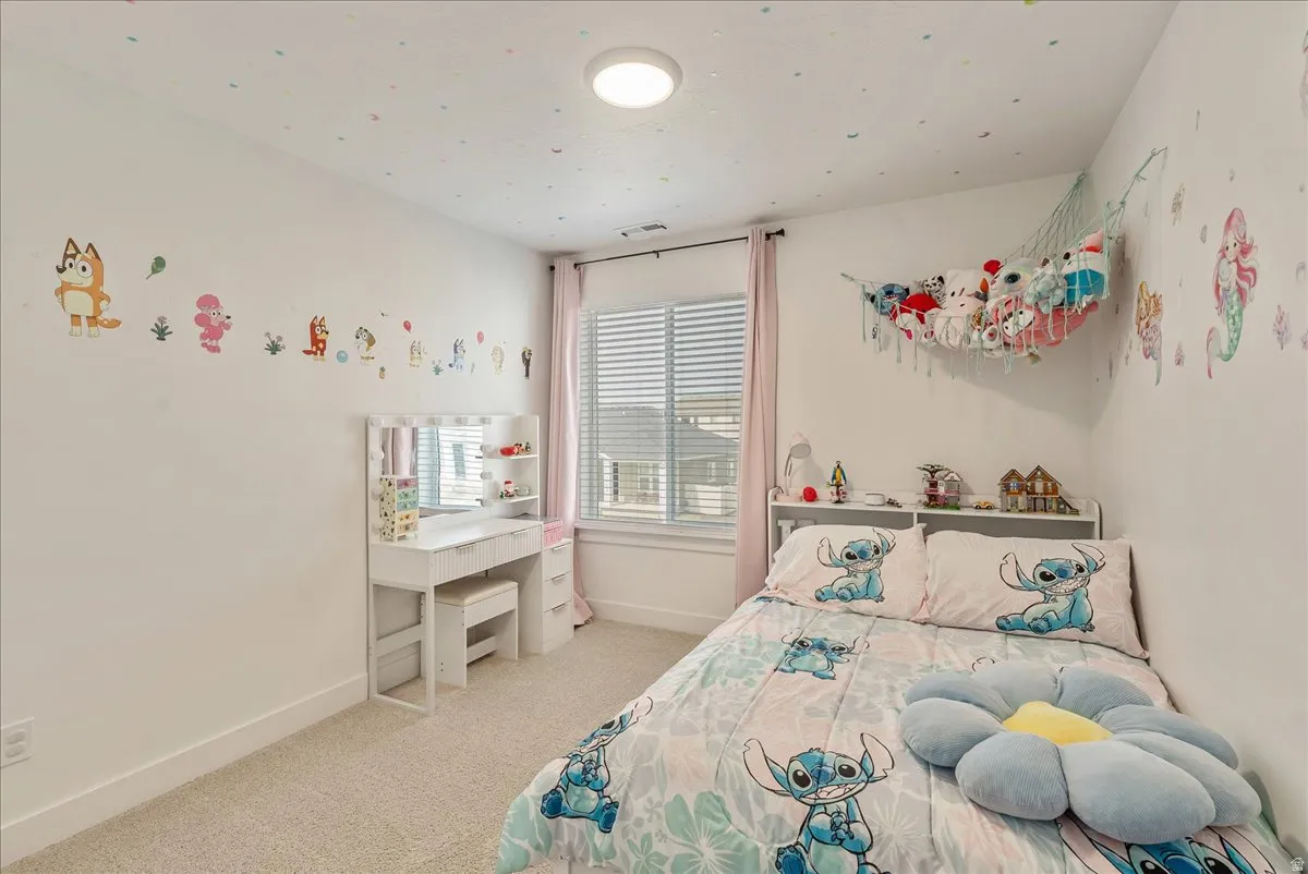 Bedroom featuring light colored carpet and baseboards