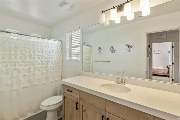 Bathroom featuring vanity, a shower with curtain, and ensuite bath