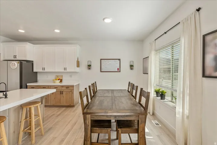 Dining area featuring light wood-style flooring and recessed lighting