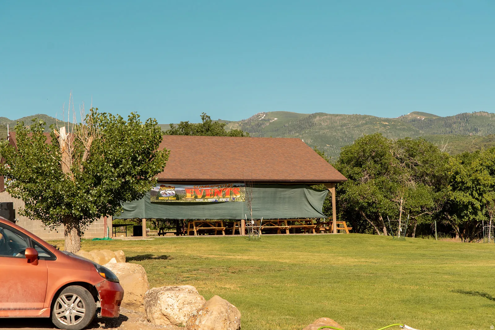 View of front of home featuring a front yard and a mountain view