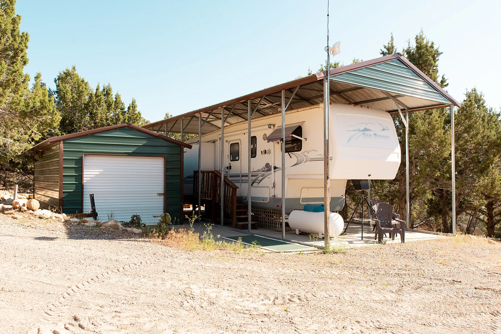 Exterior space with a patio, an outdoor structure, and a garage