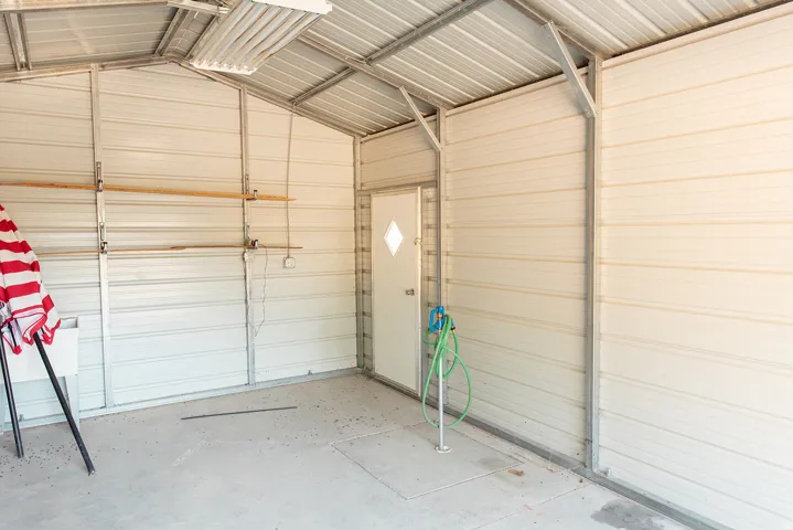 Garage featuring metal wall