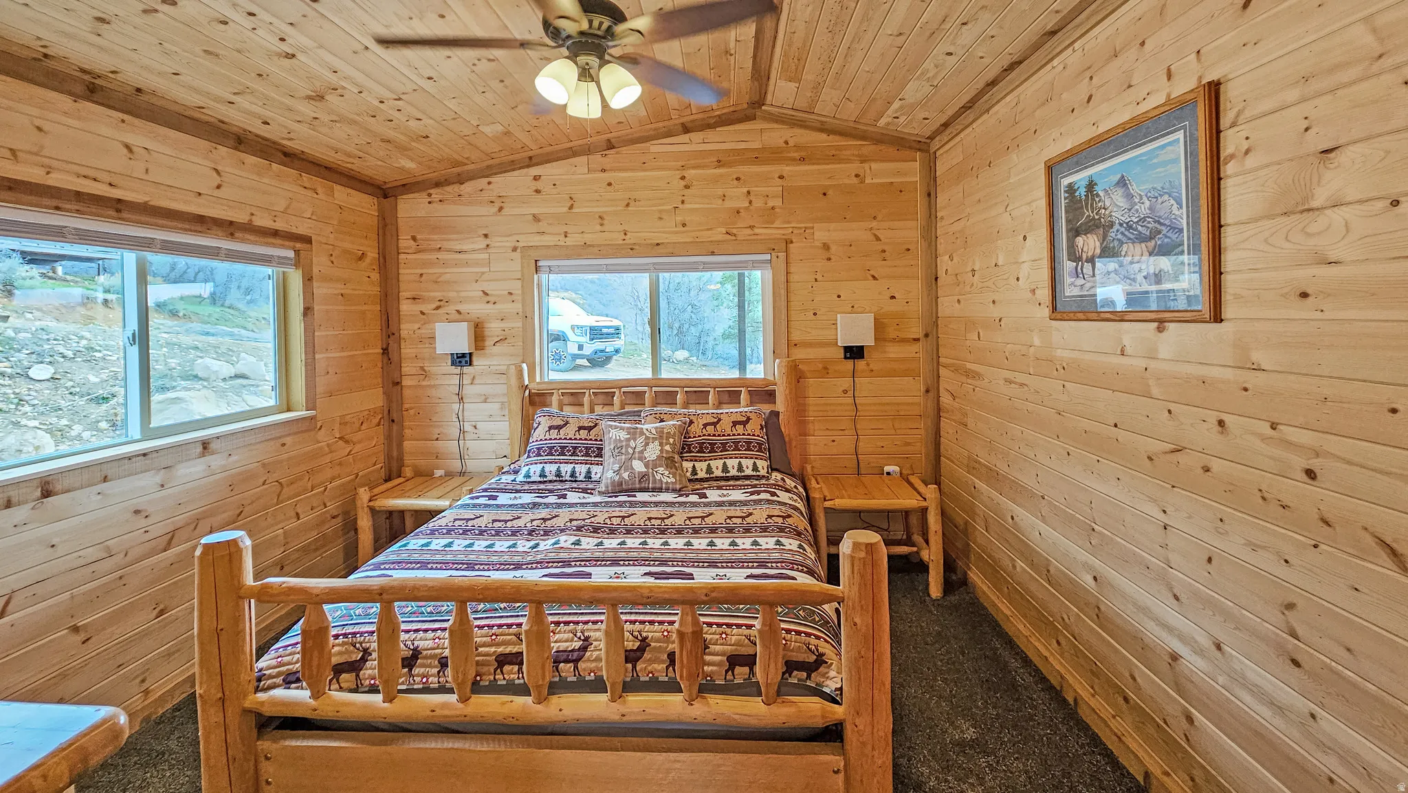 Bedroom with wood walls, a wood ceiling with exposed beams, and a ceiling fan