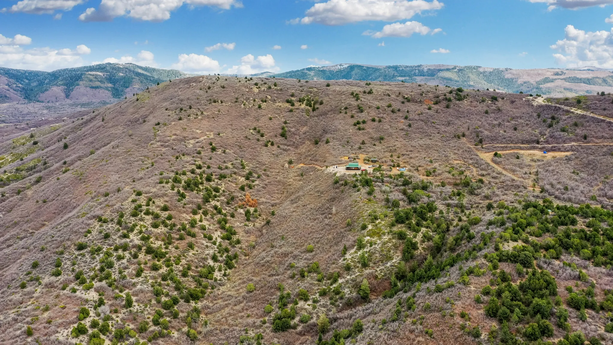View of mountain background featuring rural landscape