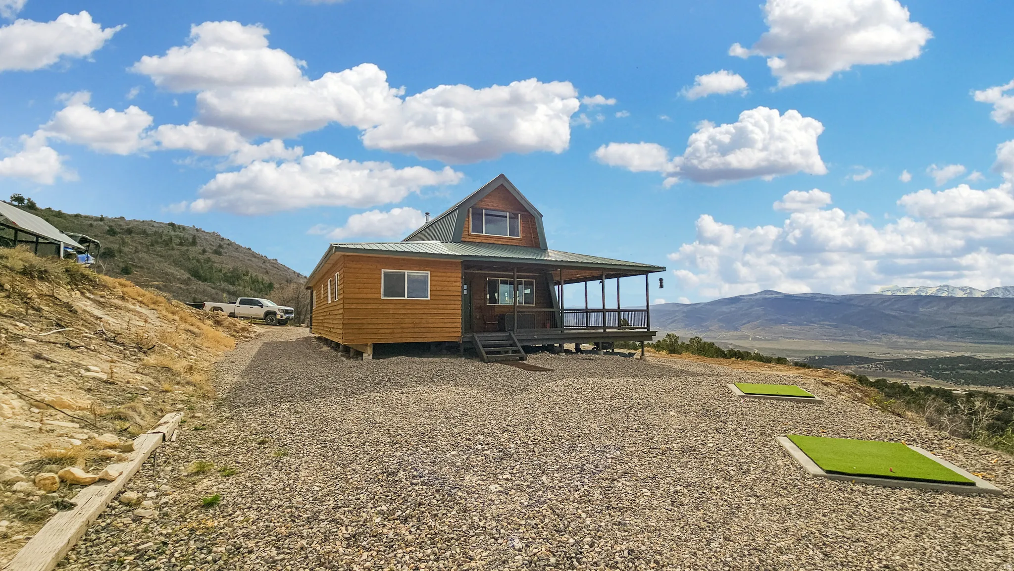 Rear view of house with a mountain view, a porch, and a metal roof