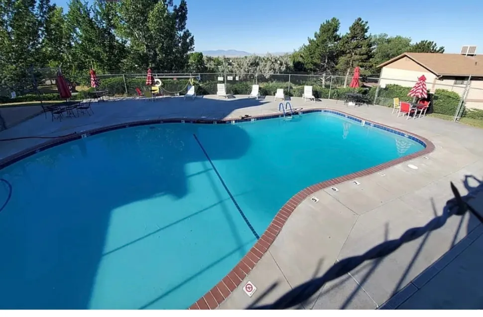 Community pool with a patio