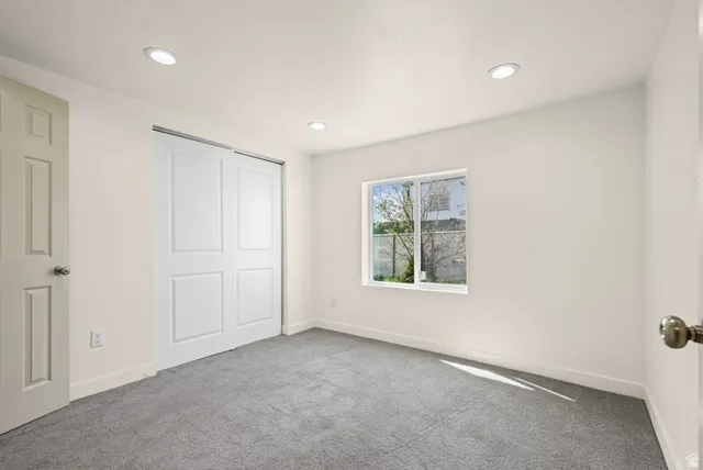 Unfurnished Primary bedroom with carpet floors, a closet, and recessed lighting