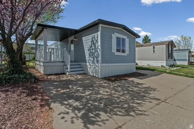 View of front of home with a wooden deck