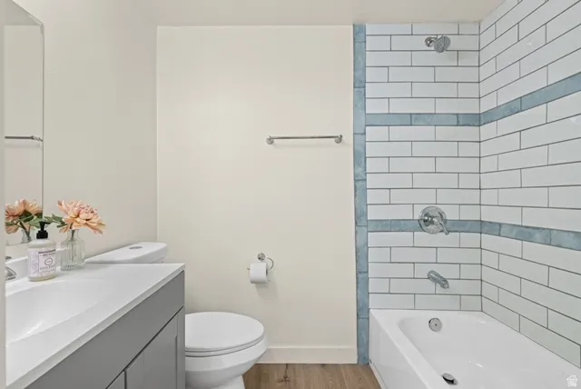 Primary Full bath with vanity,  shower combination, and light wood-style floors