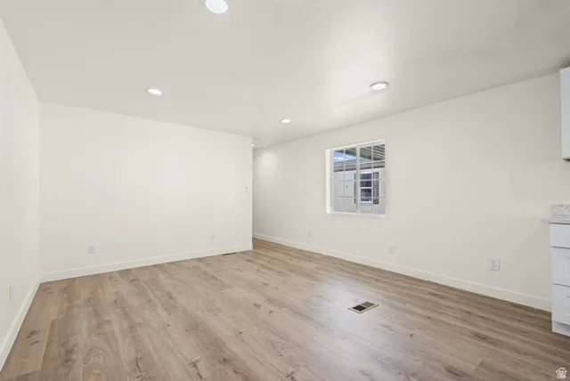 Unfurnished room with light wood finished floors and recessed lighting