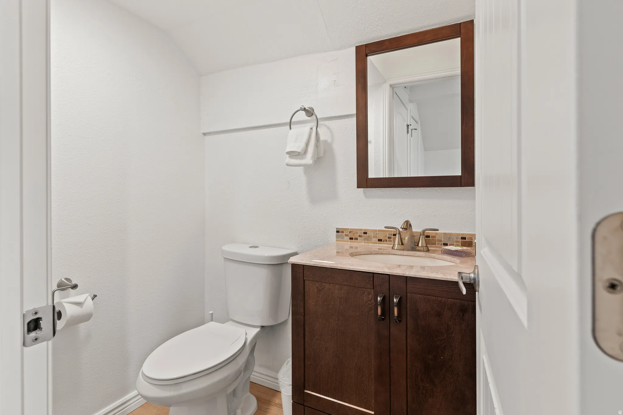 Half bathroom with vanity and toilet