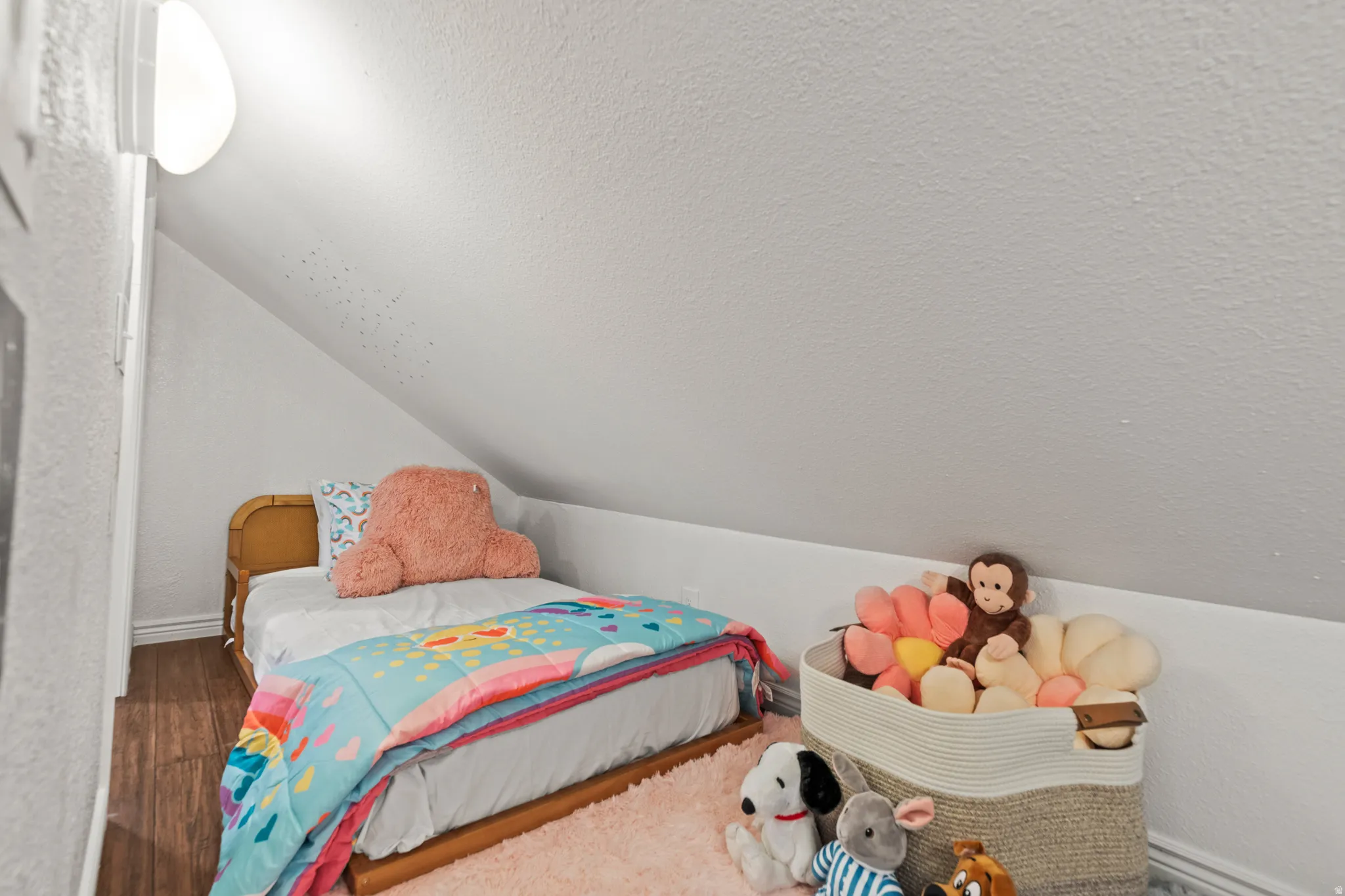 Bedroom featuring wood finished floors and baseboards