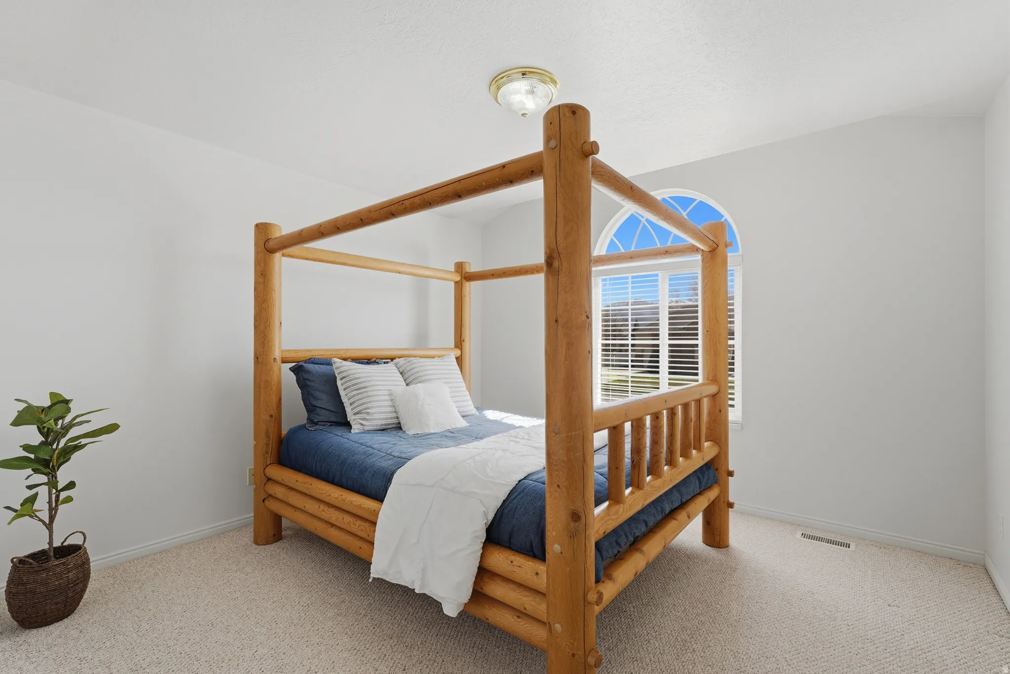 Bedroom featuring light colored carpet and baseboards