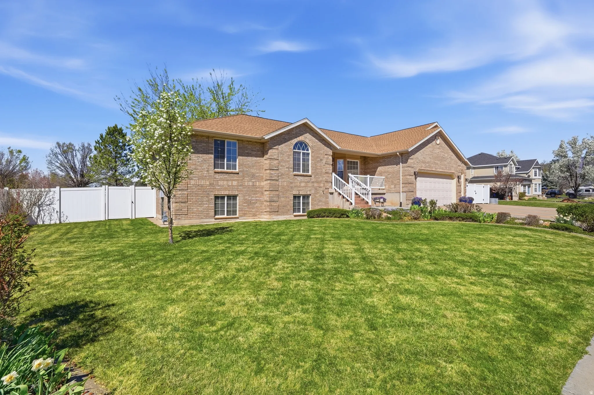 View of front of property with brick siding and a garage