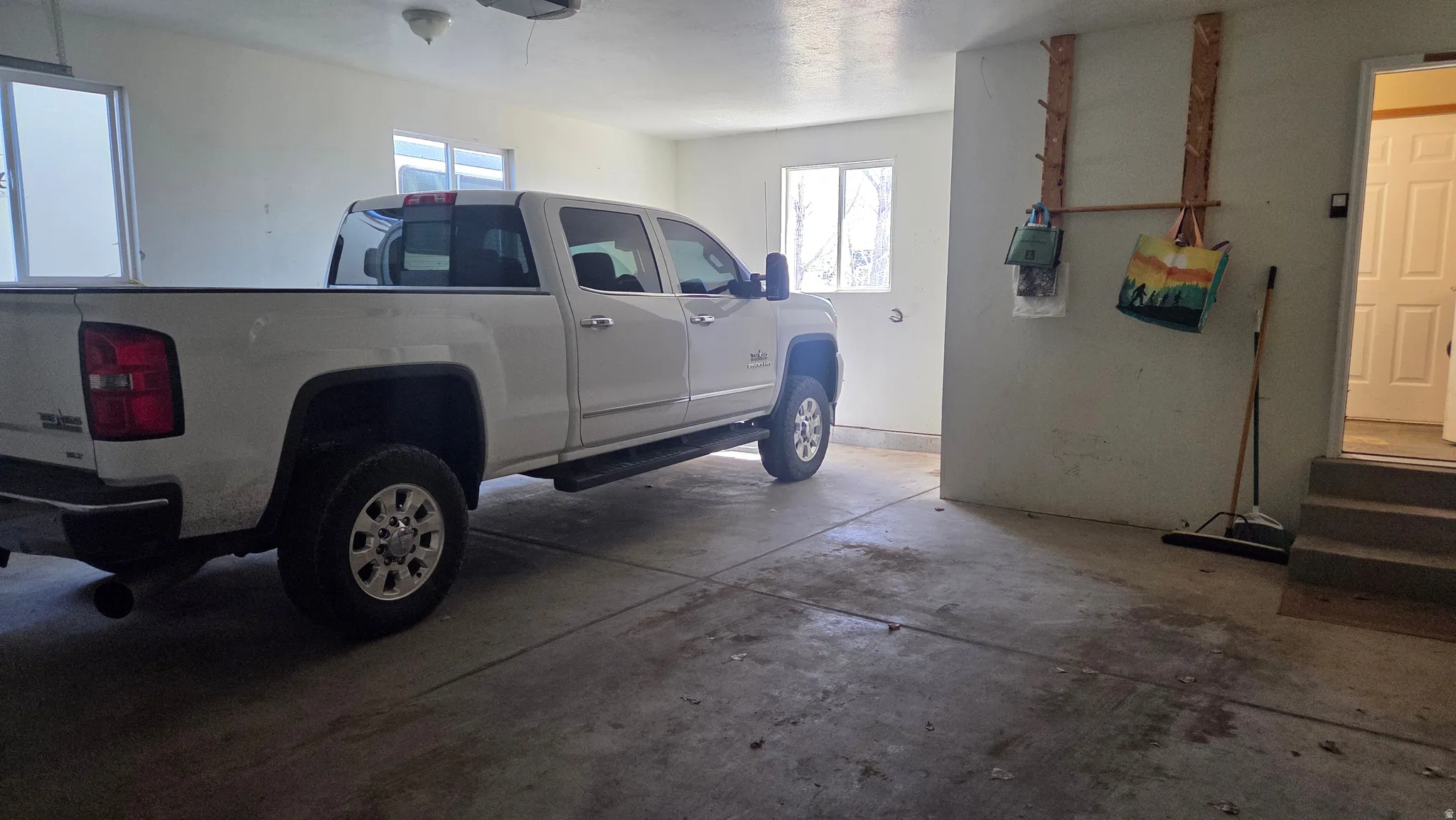 View of entry to laundry room and  garage with extra length