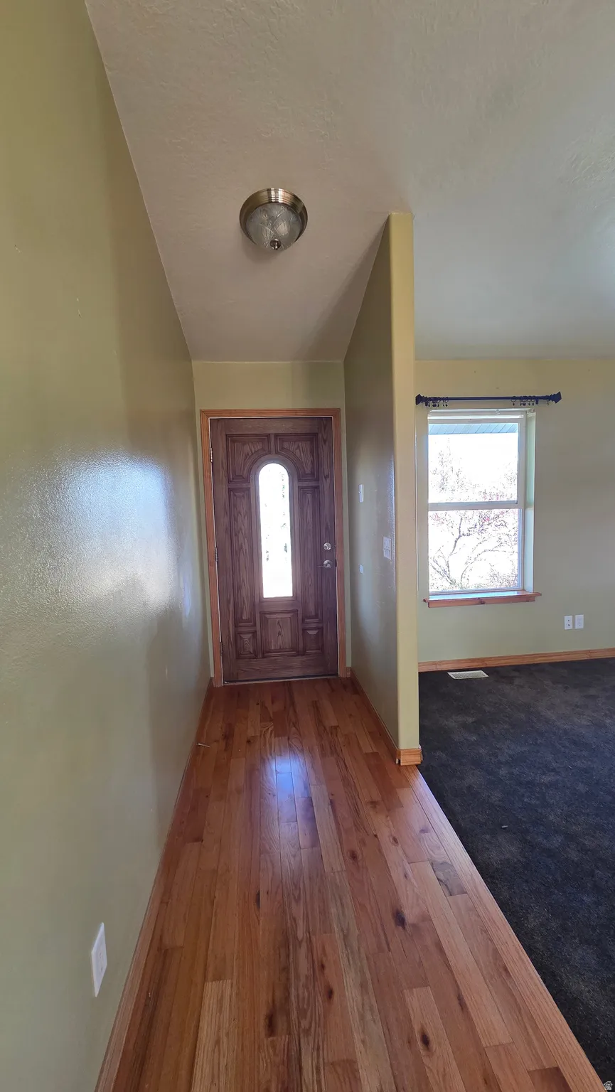 Foyer featuring hardwood / wood-style floors and a textured ceiling