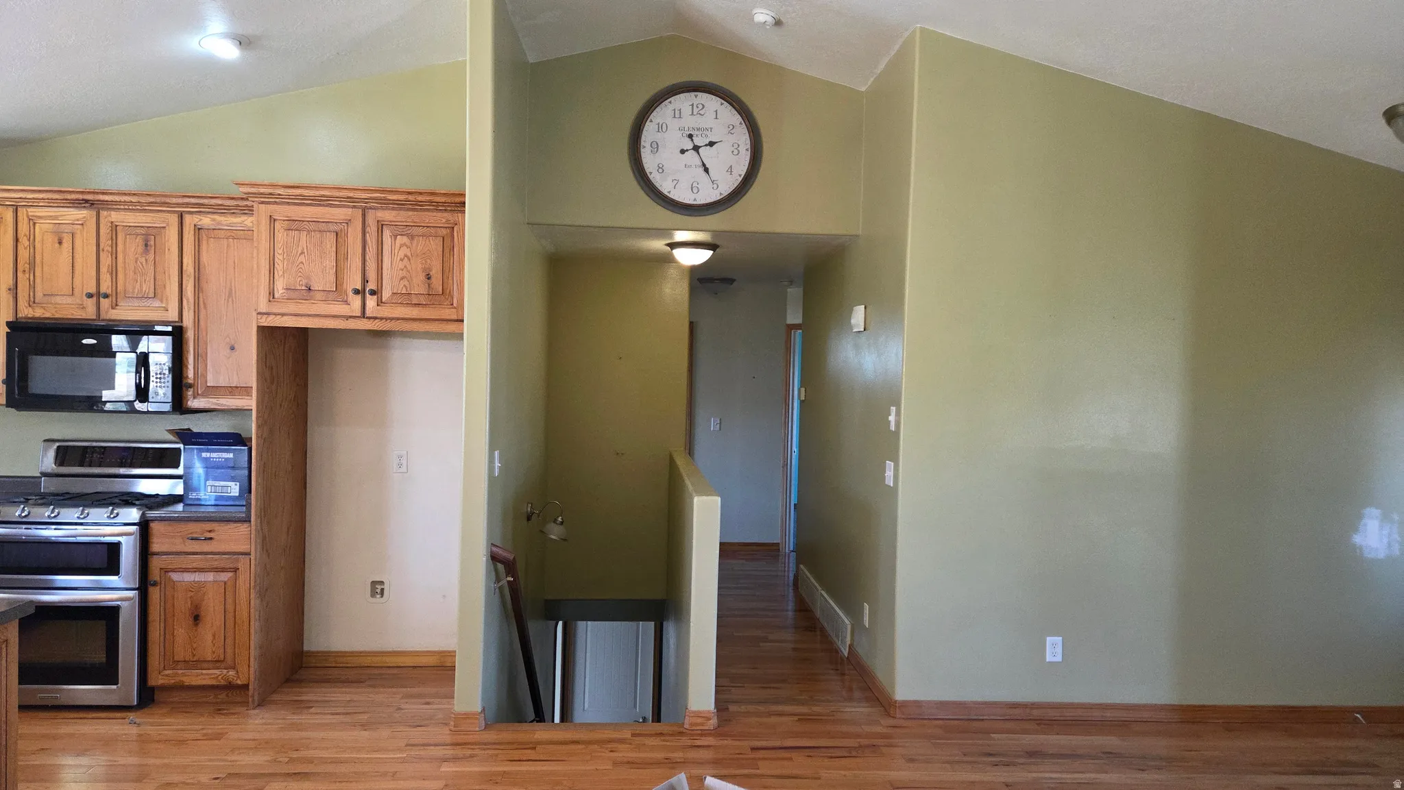 Kitchenview from living room. Entry, kitchen hallway & basement stairs