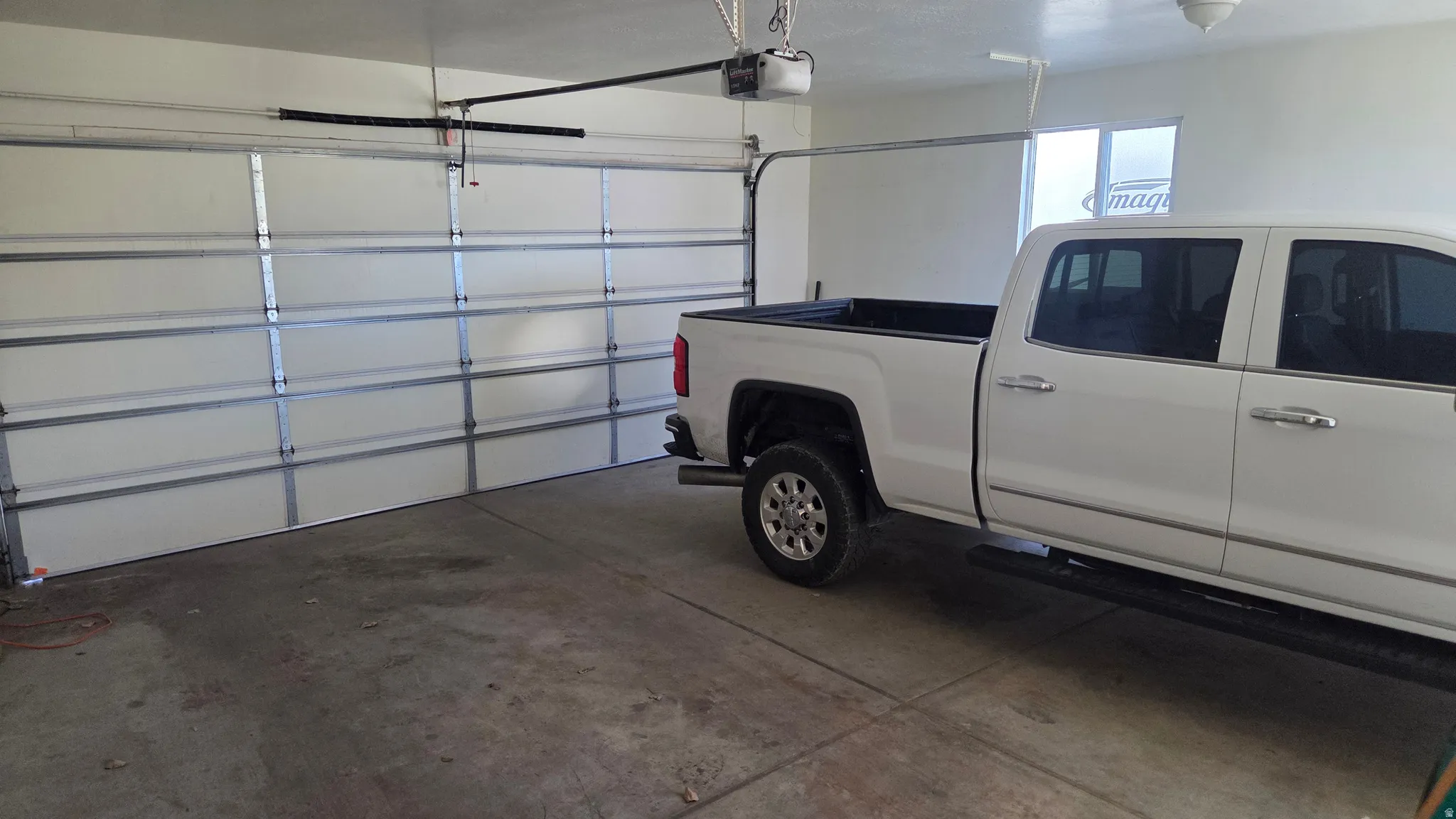 Garage featuring a garage door opener
