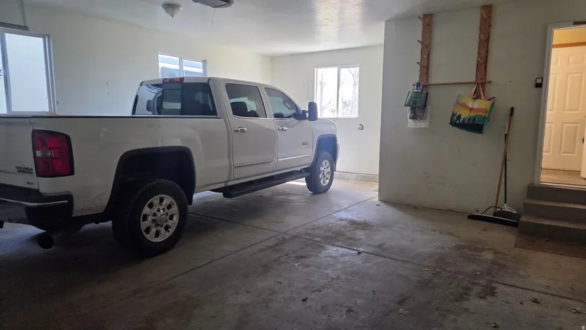 View of entry to laundry room and  garage with extra length