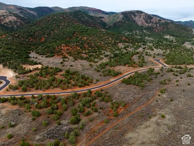 Paved road with a cul-de-sac amidst natural landscaping and mountainous terrain