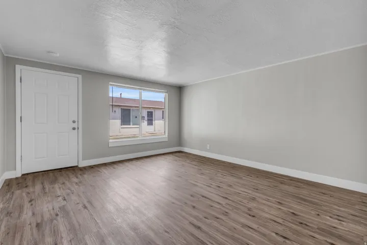 Entrance foyer with wood finished floors and a textured ceiling