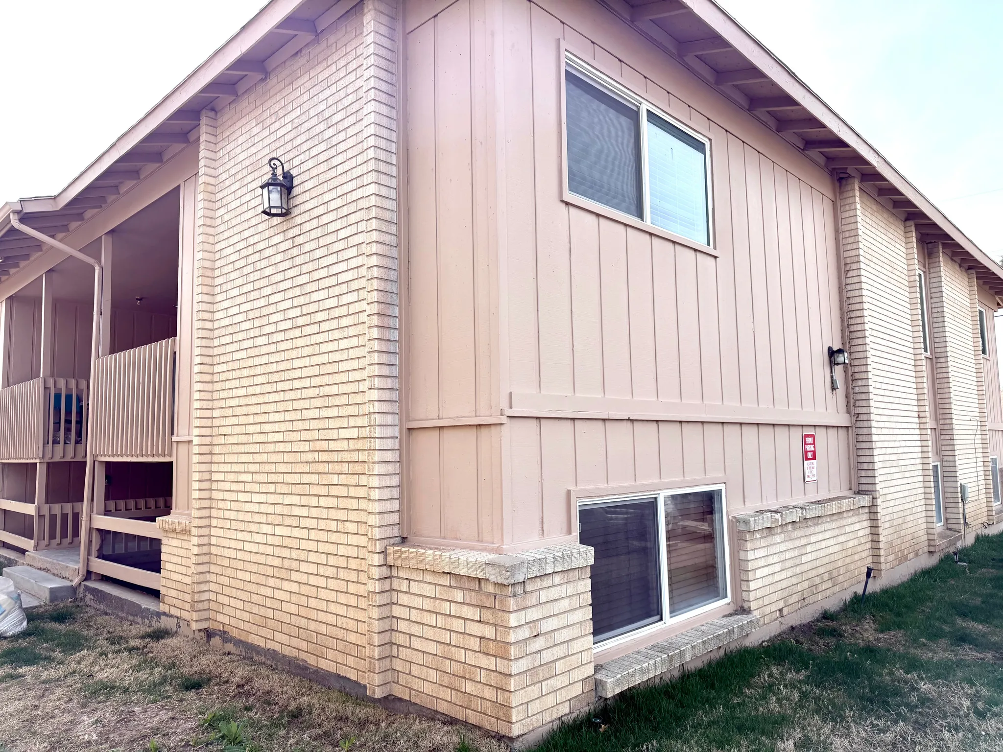View of property exterior featuring board and batten siding and brick siding