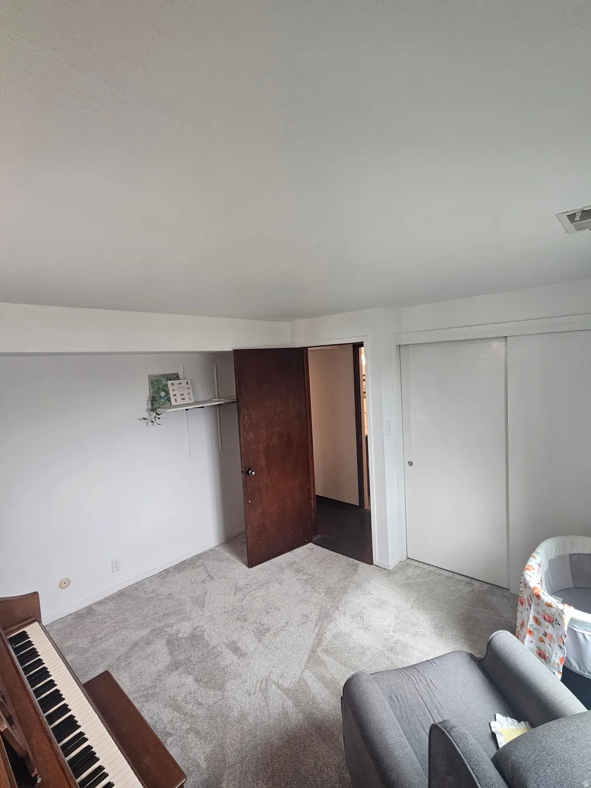 Carpeted bedroom featuring a closet and baseboards