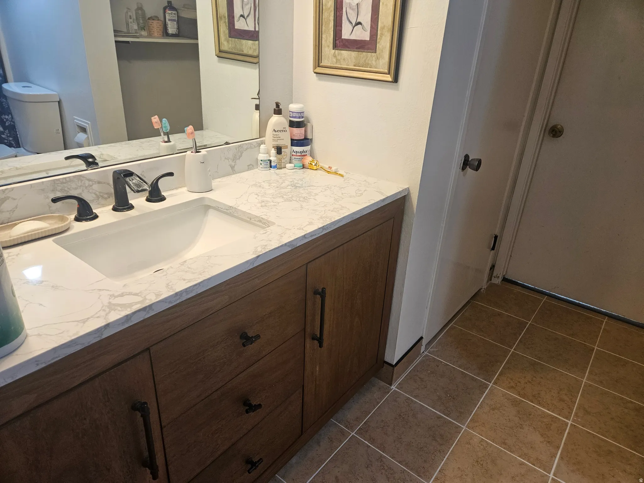 Bathroom with vanity and light tile patterned flooring