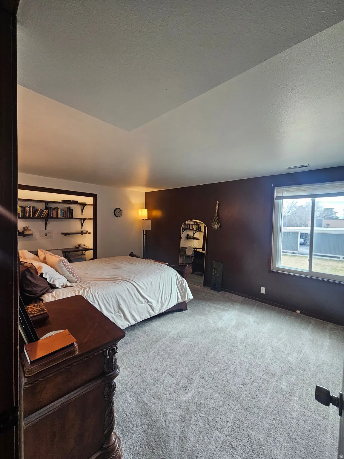 Carpeted bedroom with a textured ceiling