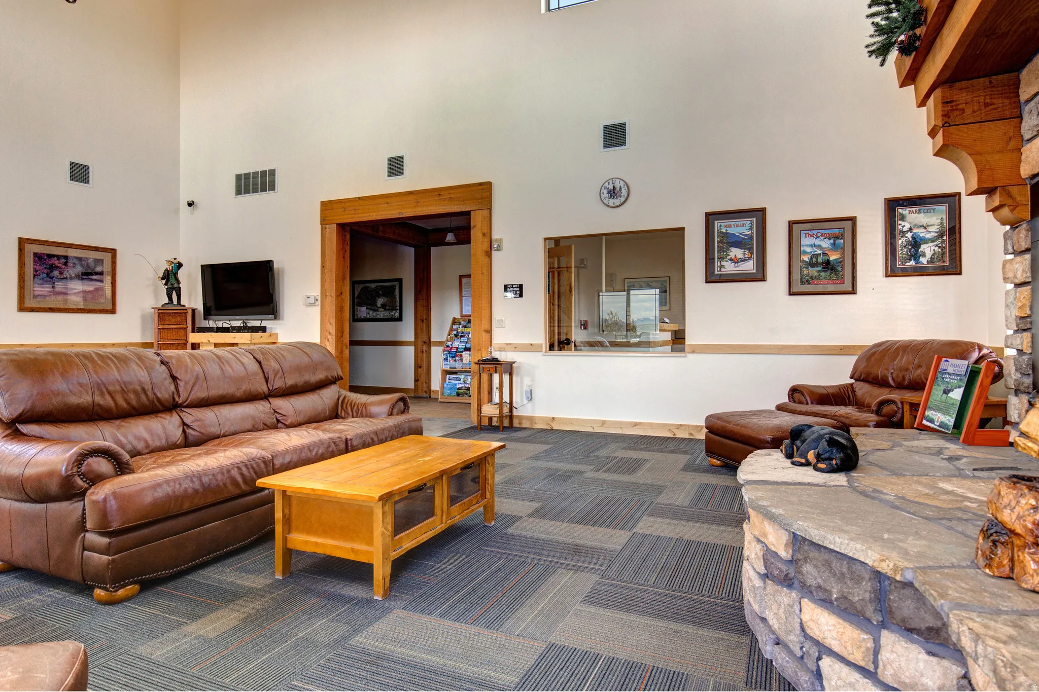 Living area with a high ceiling and dark carpet