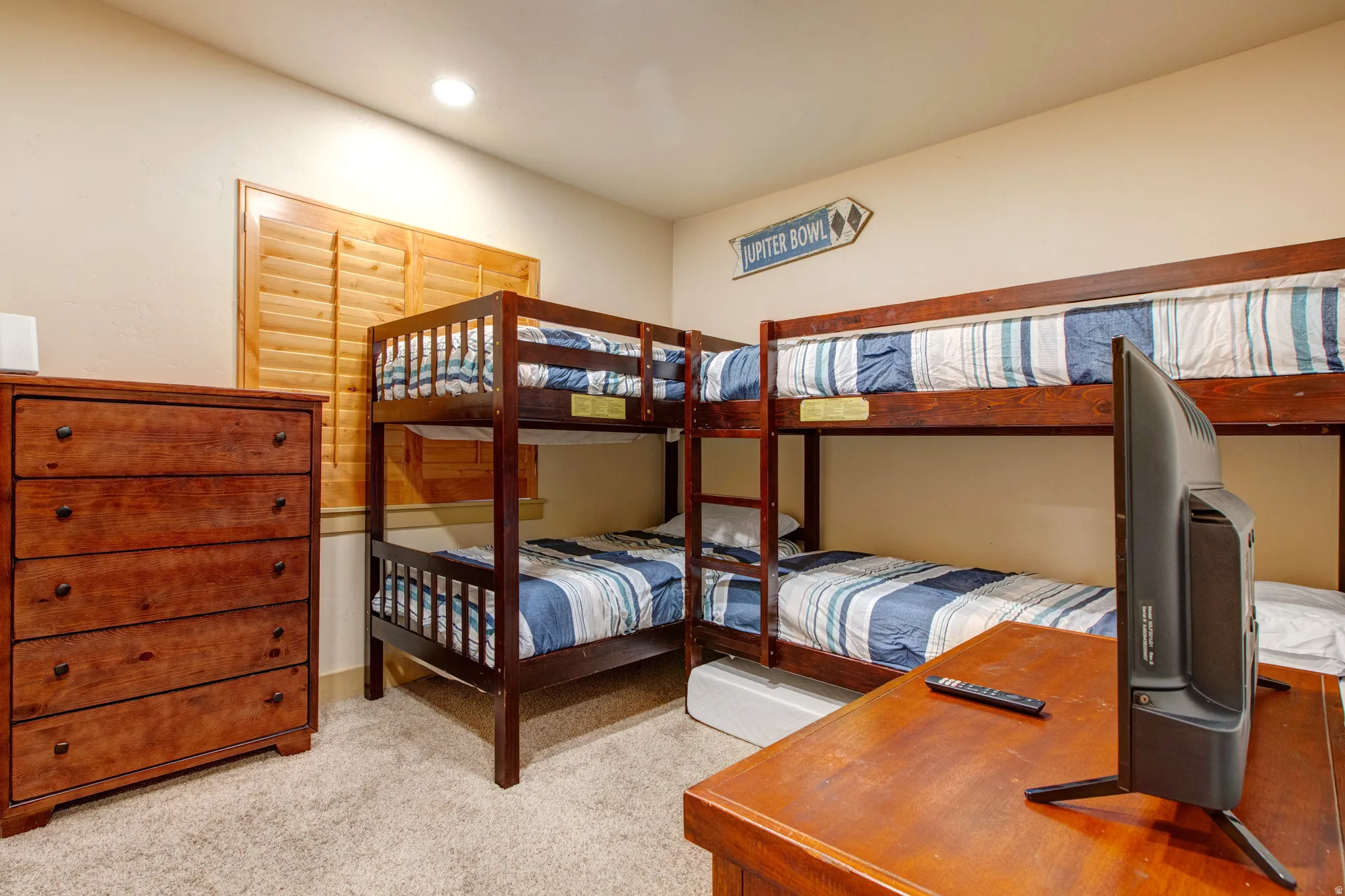 Bedroom featuring light colored carpet