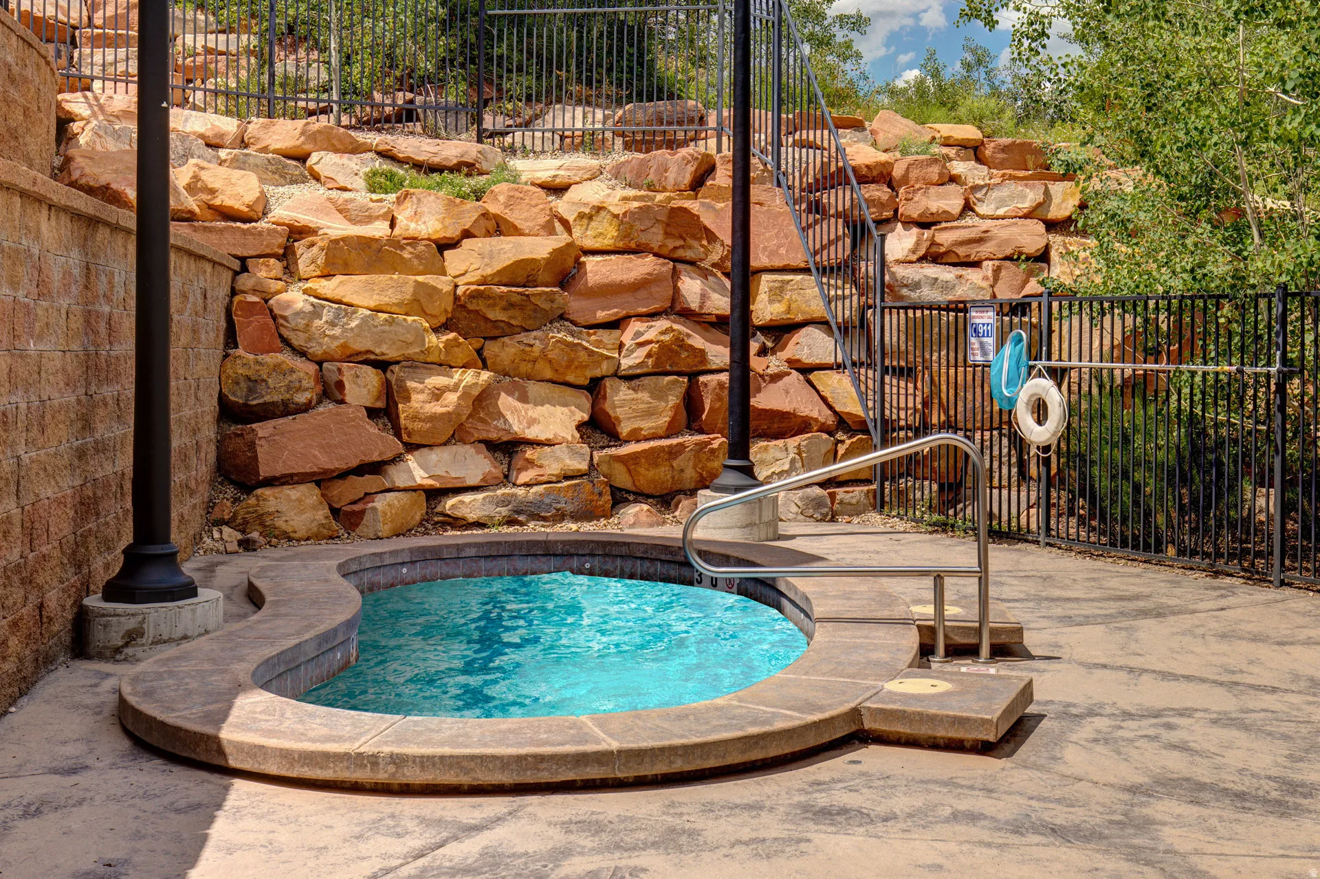 View of swimming pool with a hot tub and patio surround