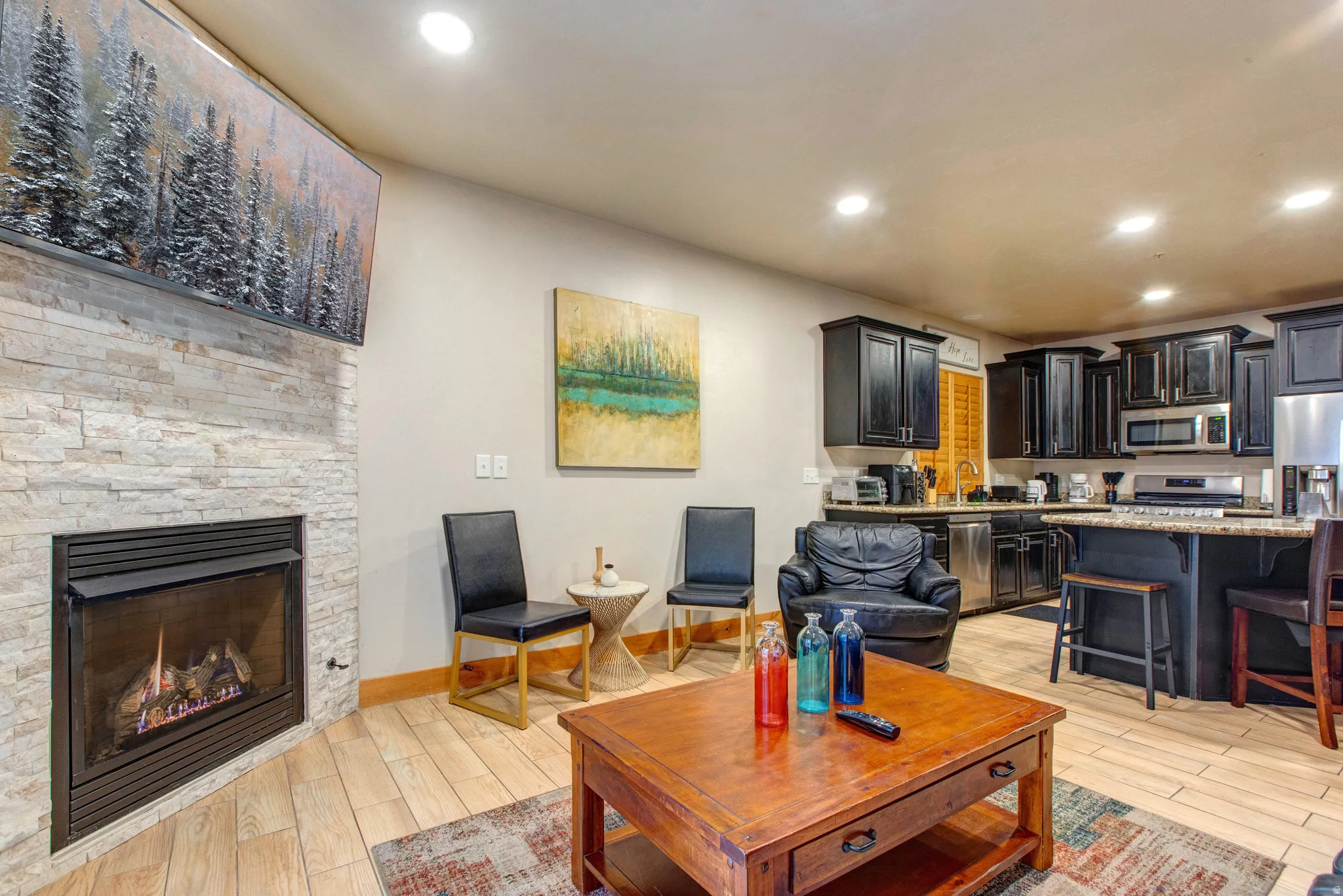 Living area with wood tiled floors, recessed lighting, and a fireplace