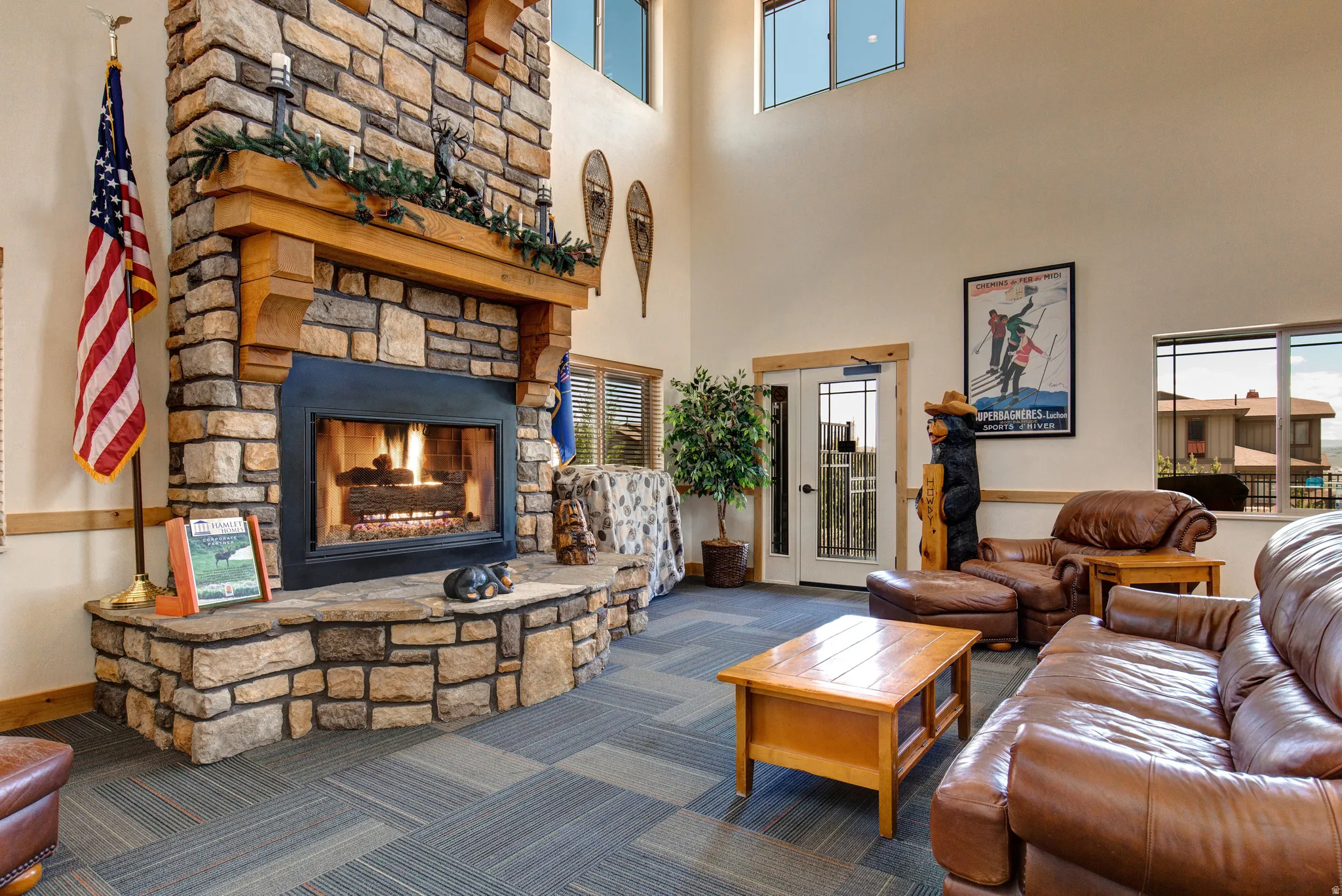 Living room featuring a fireplace, carpet, a high ceiling, and french doors