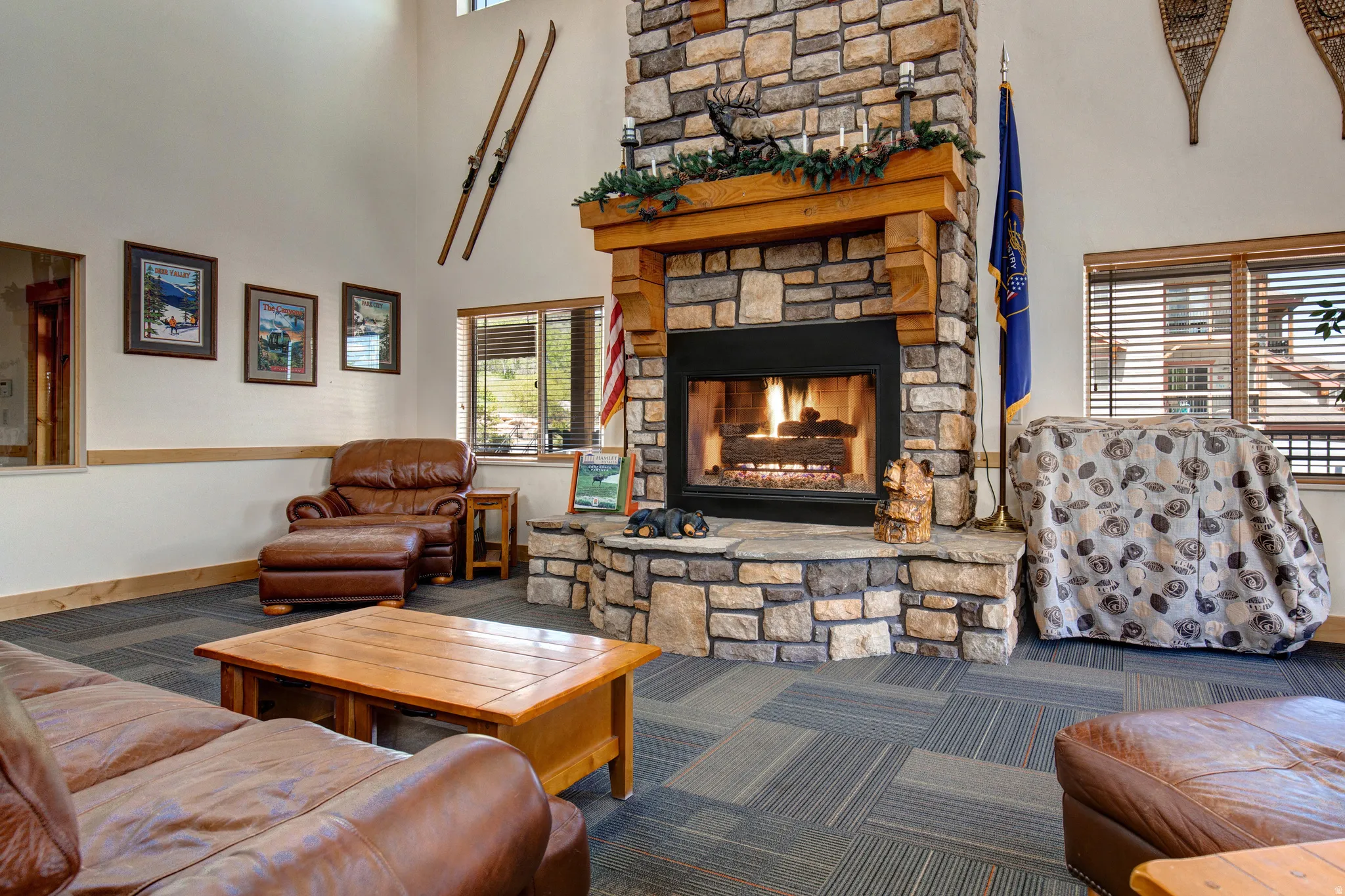 Living area with a high ceiling, carpet, and a fireplace